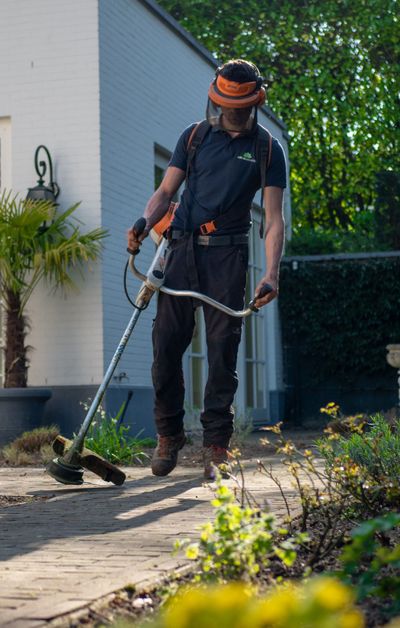 A man using a weed trimmer