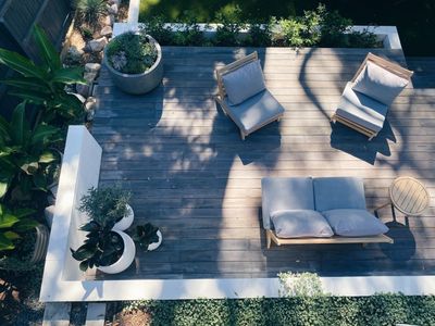 Wooden patio deck with furniture and plants